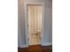 A tiled bathroom with a white door, toilet and shower area with a white shower curtain at 4685 Columbia St, Cumming, GA 30040