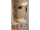 Clean bathroom featuring a tile shower with a tub, framed mirror, white vanity, and a light fixture at 4685 Columbia St, Cumming, GA 30040