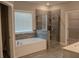 Beautiful bathroom featuring a soaking tub, glass shower, and elegant tile work at 4685 Columbia St, Cumming, GA 30040