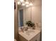 Bathroom with an oval sink, white vanity, quartz countertop, silver faucet, and a large frameless mirror at 4685 Columbia St, Cumming, GA 30040
