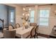Bright dining room with natural light, table set for six, modern chandelier and wood floors at 4685 Columbia St, Cumming, GA 30040