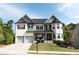 Beautiful two-story home featuring a white brick exterior, well-manicured lawn, and a two-car garage at 4685 Columbia St, Cumming, GA 30040