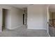 Carpeted upstairs hallway with wooden and black iron banisters at 4685 Columbia St, Cumming, GA 30040