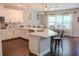 This well-equipped kitchen boasts stainless steel appliances and an island with quartz counters and seating at 4685 Columbia St, Cumming, GA 30040