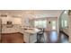 This well-equipped kitchen boasts stainless steel appliances and an island with quartz counters and seating and dining area at 4685 Columbia St, Cumming, GA 30040