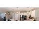 Bright kitchen with stainless steel appliances, white cabinets, pendant lighting, and breakfast bar at 4685 Columbia St, Cumming, GA 30040