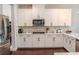 This well-equipped kitchen features stainless steel appliances and white cabinets at 4685 Columbia St, Cumming, GA 30040