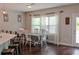Bright kitchen features white cabinets, stainless appliances and an island with bar seating and dining area at 4685 Columbia St, Cumming, GA 30040