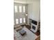 Open living room boasts a fireplace, hardwood floors, soaring windows, and plush sectional sofa at 4685 Columbia St, Cumming, GA 30040