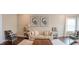Spacious living room featuring a tufted sofa, plush rug, stylish decor, and neutral walls at 4685 Columbia St, Cumming, GA 30040