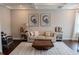 Comfortable living room with a tufted sofa, wood floors, coffered ceilings, and bright, neutral paint at 4685 Columbia St, Cumming, GA 30040