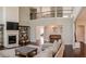 This open living room features a fireplace, lots of natural light, and hardwood flooring at 4685 Columbia St, Cumming, GA 30040