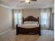 Large main bedroom with tray ceiling, carpet floors, and elegant furnishings at 4685 Columbia St, Cumming, GA 30040