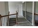Carpeted staircase with wooden banister and black iron balusters leading to the upper level at 4685 Columbia St, Cumming, GA 30040