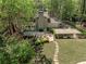 Stunning aerial view of the property showcasing the landscaped yard, patio, and wooded surroundings at 965 River Overlook Ct, Sandy Springs, GA 30328