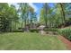 Spacious backyard with lush green grass enclosed by a fence and mature trees at 965 River Overlook Ct, Sandy Springs, GA 30328
