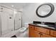 Modern bathroom with black and white floors, subway tile shower and granite countertop on a wood vanity at 965 River Overlook Ct, Sandy Springs, GA 30328