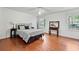 Spacious bedroom featuring hardwood floors, large windows with a picturesque view, and a modern ceiling fan at 965 River Overlook Ct, Sandy Springs, GA 30328
