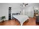Bright bedroom with hardwood floors, neutral walls featuring a shelf and a view into the bathroom at 965 River Overlook Ct, Sandy Springs, GA 30328
