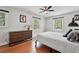 Modern bedroom with hardwood floors, neutral walls and featuring a stylish dresser and a window view at 965 River Overlook Ct, Sandy Springs, GA 30328