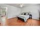 Sunlit bedroom showcasing wood floors, white walls and ceiling, complemented by views into the ensuite bathroom at 965 River Overlook Ct, Sandy Springs, GA 30328
