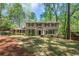 Charming home featuring a large front yard, traditional architecture, and mature trees at 965 River Overlook Ct, Sandy Springs, GA 30328