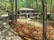 Exterior view of the property showcasing its well-manicured lawn and mature trees at 965 River Overlook Ct, Sandy Springs, GA 30328
