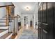 Inviting foyer with a wood staircase, tile flooring, and a view into the living spaces at 965 River Overlook Ct, Sandy Springs, GA 30328