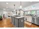 Open kitchen with granite counters, stainless appliances, and skylights offers natural light at 965 River Overlook Ct, Sandy Springs, GA 30328