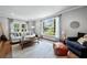 Bright living room featuring hardwood floors, ample seating, and large windows offering natural light at 965 River Overlook Ct, Sandy Springs, GA 30328