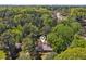 Bird's eye view of home in a tree filled neighborhood with distant city skyline at 1496 Country Squire Dr, Decatur, GA 30033