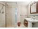 Stylish bathroom with a glass-enclosed shower, elegant pedestal sink, and neutral color palette at 1496 Country Squire Dr, Decatur, GA 30033