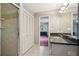 Bathroom featuring a tile shower and black granite countertop at 1496 Country Squire Dr, Decatur, GA 30033