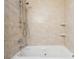 Elegant bathtub with tiled walls, adjustable shower head, and sleek fixtures at 1496 Country Squire Dr, Decatur, GA 30033