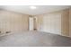 Cozy bedroom featuring carpeted floors, a built-in closet, and wood-paneled walls at 1496 Country Squire Dr, Decatur, GA 30033