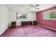 Vintage bedroom featuring pink plaid wallpaper, a ceiling fan, and two windows at 1496 Country Squire Dr, Decatur, GA 30033