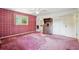 Vintage bedroom featuring pink plaid wallpaper, carpet, and an attached bathroom at 1496 Country Squire Dr, Decatur, GA 30033