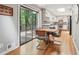 Charming dining area with hardwood floors, sliding glass doors, and a view into the modern kitchen at 1496 Country Squire Dr, Decatur, GA 30033