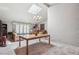 Bright dining room with chandelier, patterned wall, and opens to spacious living room at 1496 Country Squire Dr, Decatur, GA 30033