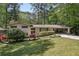Charming brick home with a well-manicured lawn, mature trees, and a convenient attached carport at 1496 Country Squire Dr, Decatur, GA 30033