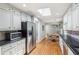 Spacious kitchen with hardwood floors, granite counters, and stainless steel appliances and refigerator at 1496 Country Squire Dr, Decatur, GA 30033