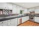 Well-lit kitchen featuring granite countertops, stainless steel appliances, and ample white cabinetry at 1496 Country Squire Dr, Decatur, GA 30033