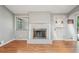 Comfortable living room with hardwood floors, fireplace, and a door leading to the outdoor space at 1496 Country Squire Dr, Decatur, GA 30033