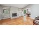Inviting living room with hardwood floors, fireplace, and an open layout to the dining area and kitchen at 1496 Country Squire Dr, Decatur, GA 30033