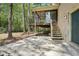 Backyard patio area with stairs leading to a screened in porch, brick exterior and lovely trees at 1496 Country Squire Dr, Decatur, GA 30033