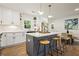 Modern kitchen with white cabinets, a gray island, and stainless steel appliances at 1995 Mcafee Rd, Decatur, GA 30032
