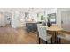 Modern kitchen featuring an island with seating, stainless-steel appliances, and hardwood floors at 1995 Mcafee Rd, Decatur, GA 30032