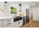 Bright kitchen with white cabinets, stone countertops, stainless steel appliances, and view to green outdoors at 1995 Mcafee Rd, Decatur, GA 30032