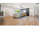 Open-concept living room with hardwood floors offering a view of the foyer and an accent wall at 1995 Mcafee Rd, Decatur, GA 30032