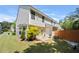 View of a well-manicured backyard with a patio, lush greenery, and a wooden fence at 625 Outlook Way, Atlanta, GA 30349
